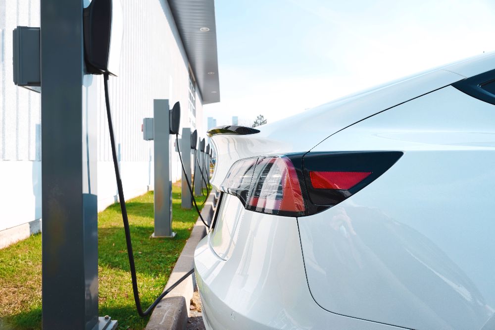 Electric vehicles charging in a car park.